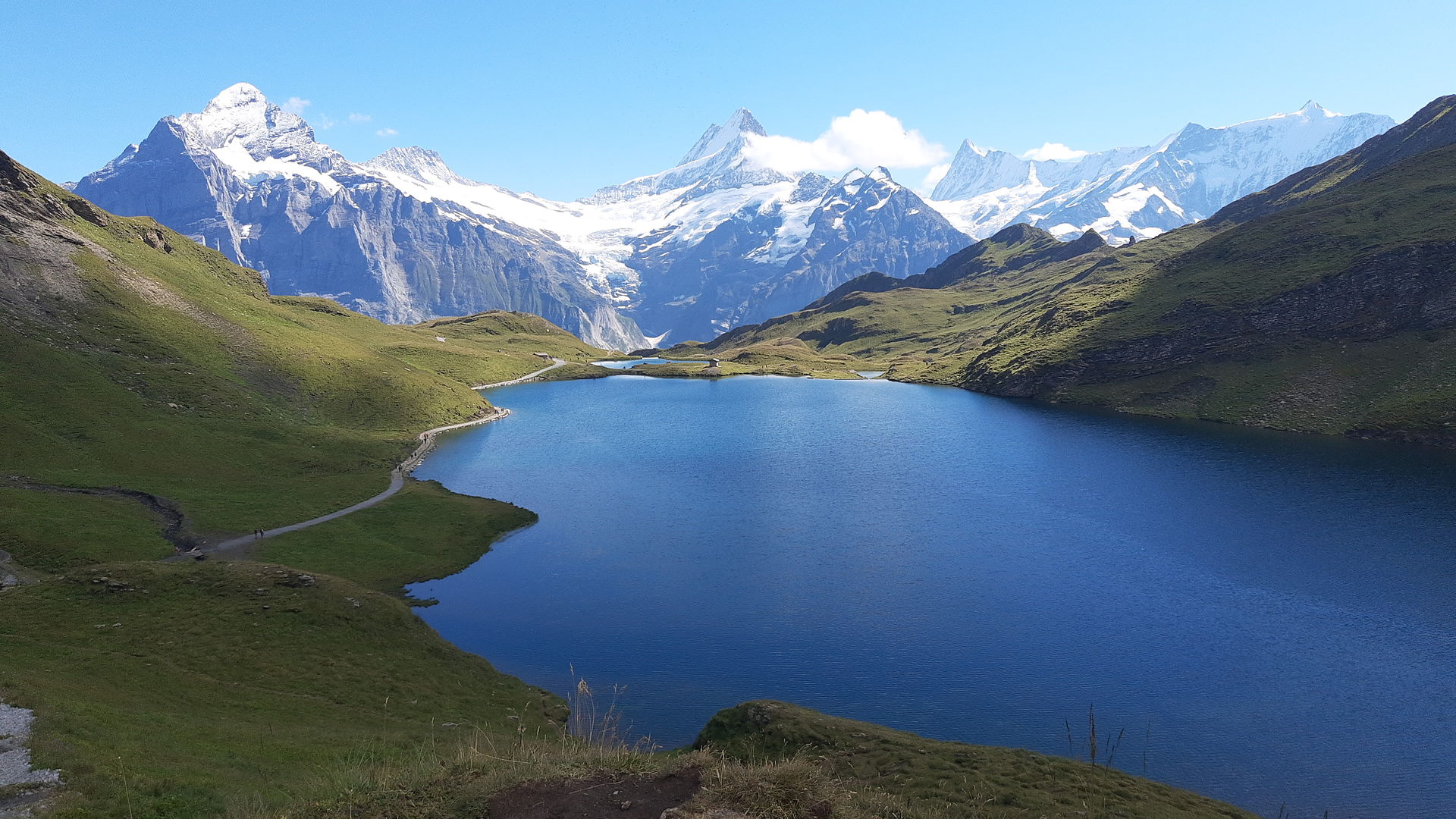 Alpine lake beneath snow-covered peaks