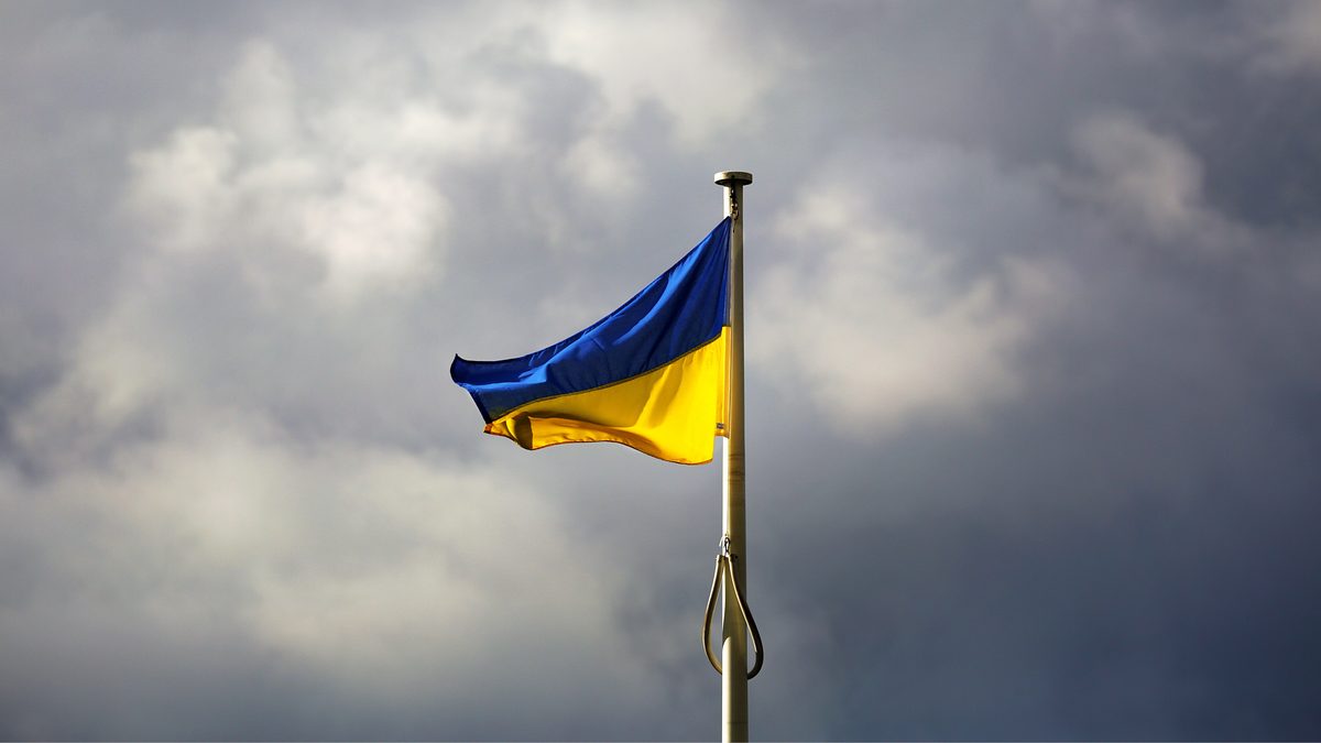Ukrainian flag flying against a stormy sky